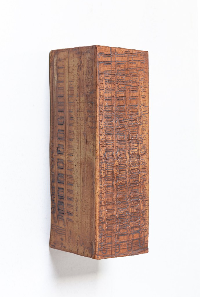 Side view of a wall-mounted ceramic from Scaffolds: Ceramic, 2026, by Matt King. Ceramic.