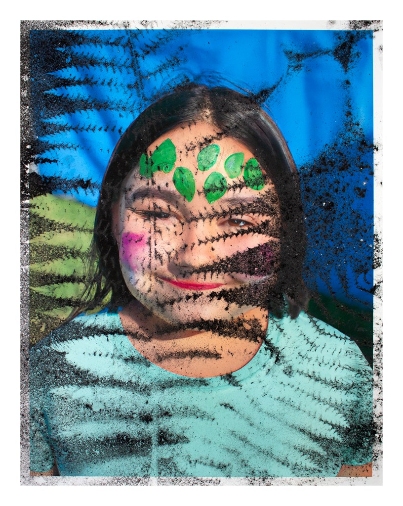 Print of an AI-generated child with face paint, from AI Face Paint (print), 2023, by Matt King. Inkjet print of an AI-generated image, dusted with iron oxide through foliage collected on site.